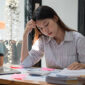 Pngtree conceptualizing corporate stress an overburdened business professional exhausted during a meeting depicting work stress and migraine within the work environment photo image 49668316